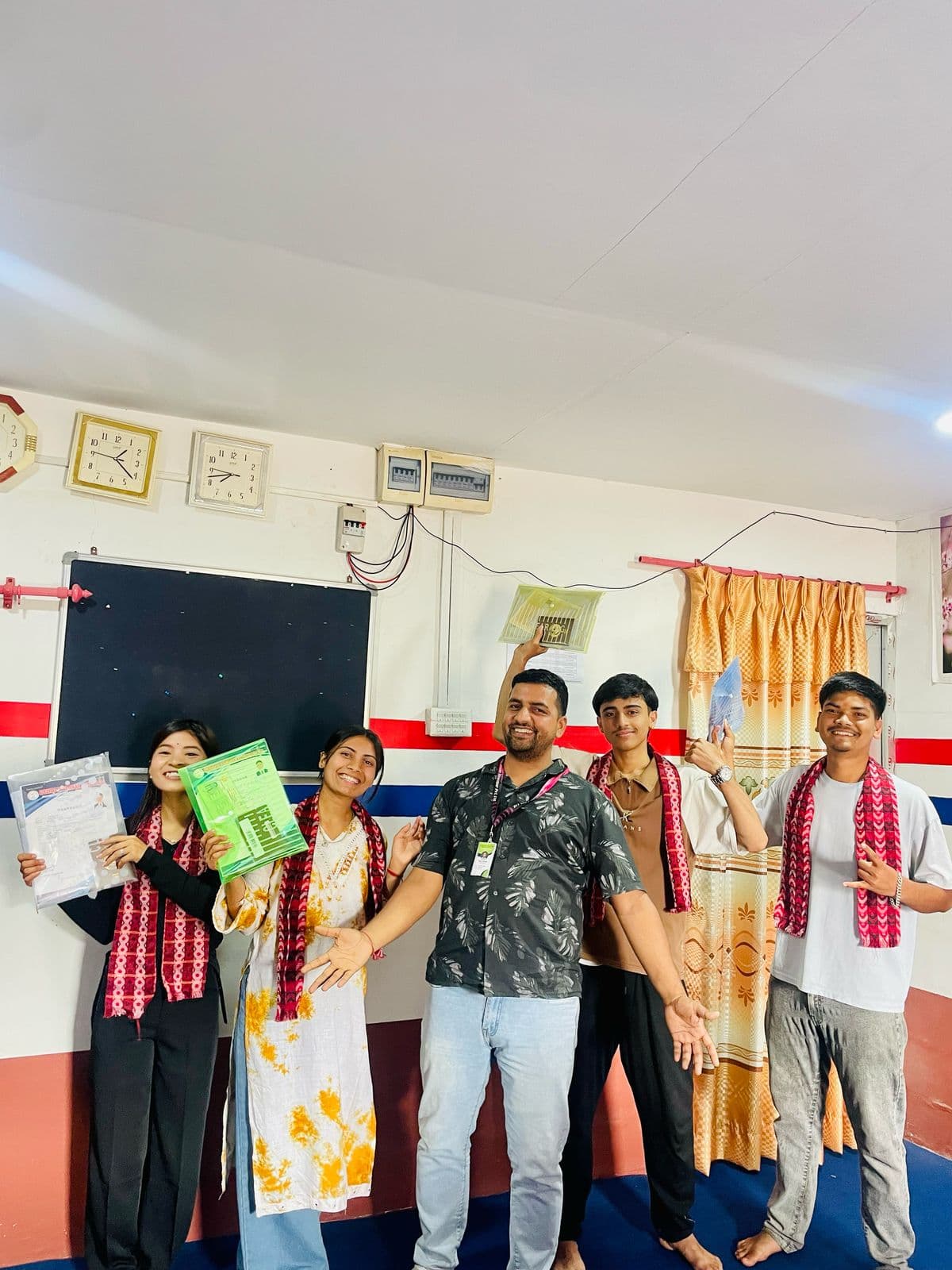 Group photo of departing students with Achievers Education banners